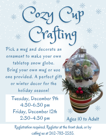 Decorated clear plastic ornament with winter scene in interior on top of a holiday mug to resemble a snow globe.